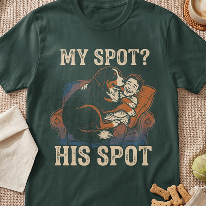 Bernese mountain dog hugs laughing boy on chair with text "MY SPOT? HIS SPOT."