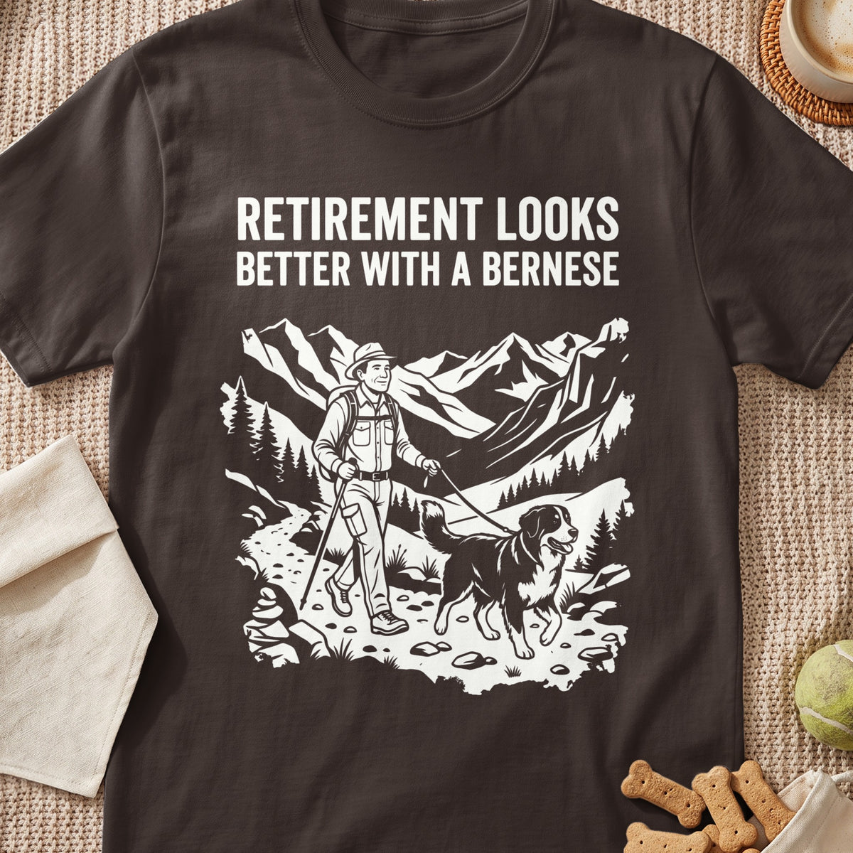T-shirt with "Retirement looks better with a Bernese" text and mountain hiking illustration.