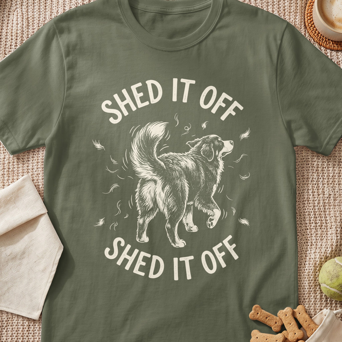 Green t-shirt with a dog shedding hair and the text "SHED IT OFF".