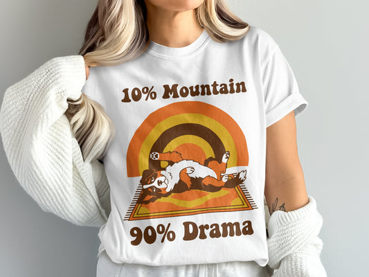 White t-shirt with retro rainbow graphic, a dog, and text "10% Mountain 90% Drama".