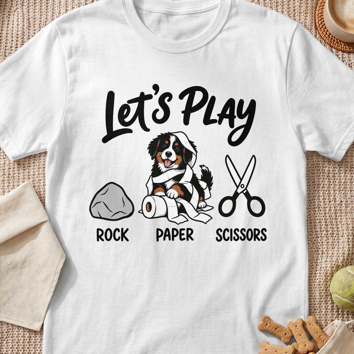 Bernese Mountain Dog puppy wrapped in toilet paper, with rock, paper, scissors text.
