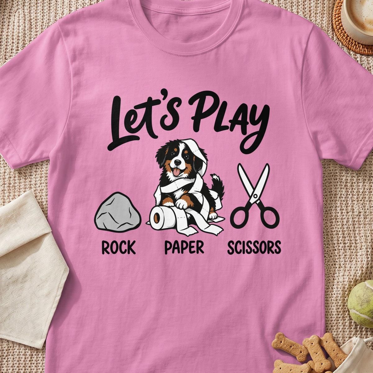 Pink t-shirt with a Bernese Mountain Dog tangled in toilet paper and "Let's Play Rock Paper Scissors" text.