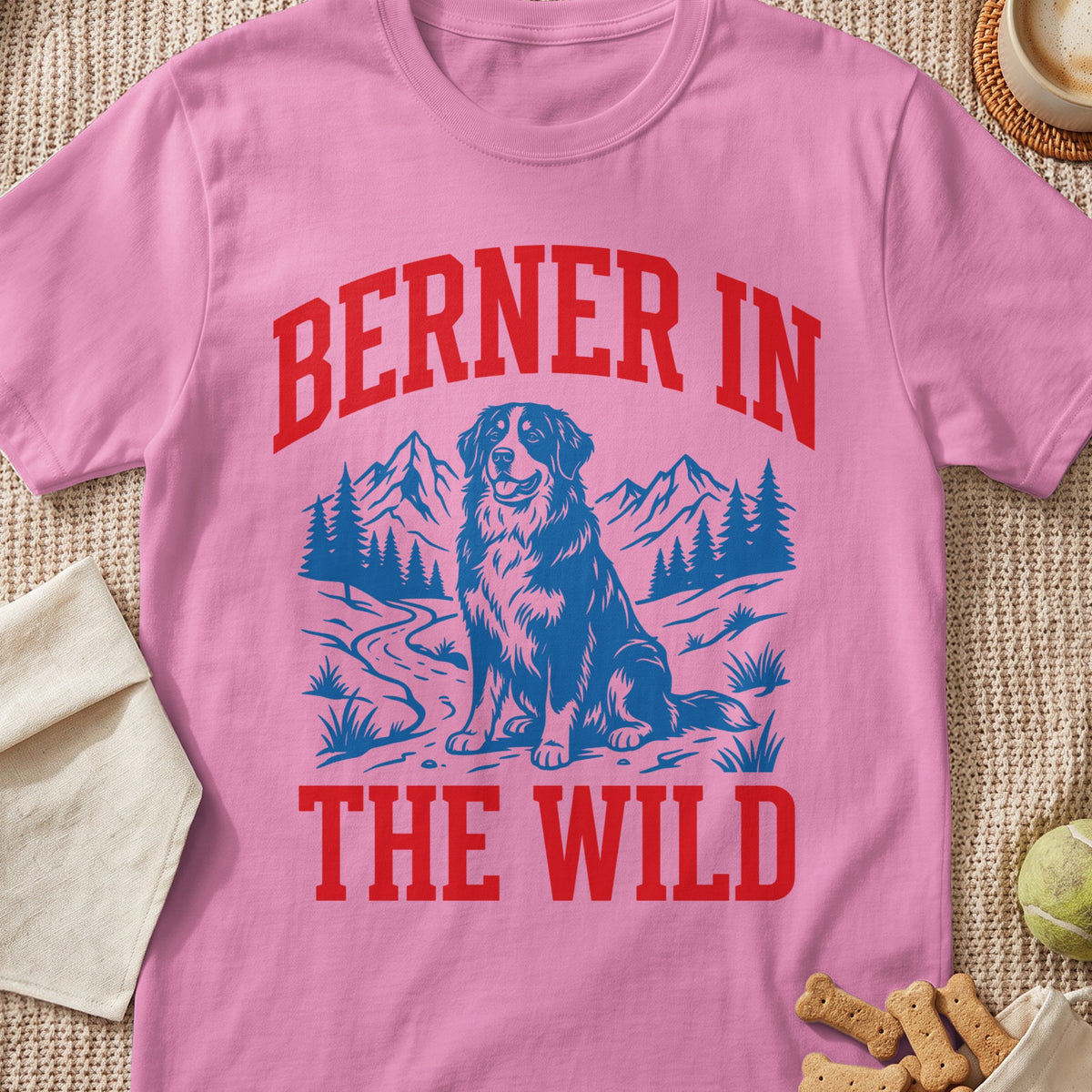 Pink t-shirt with "Berner In The Wild" text and a blue graphic of a dog in mountains.