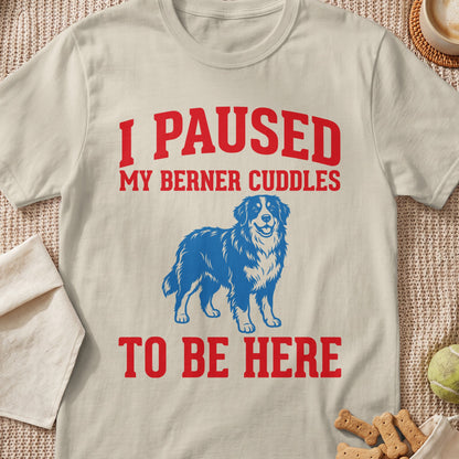 Cream t-shirt with red text "I PAUSED MY BERNER CUDDLES TO BE HERE" and blue dog graphic.
