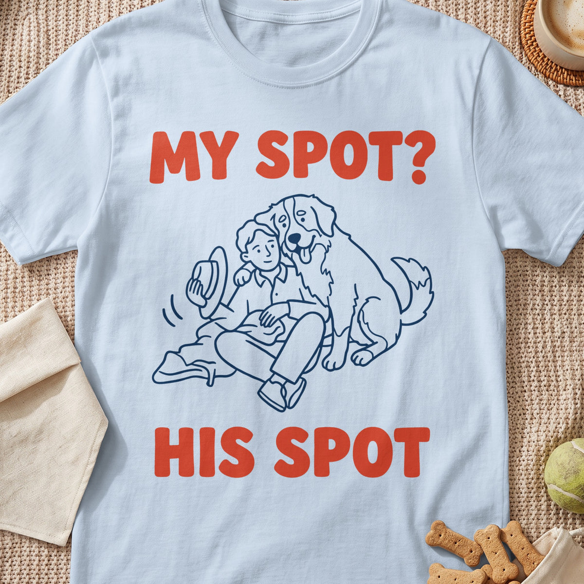 Light blue t-shirt with line drawing of person and dog, text reads "MY SPOT? HIS SPOT".