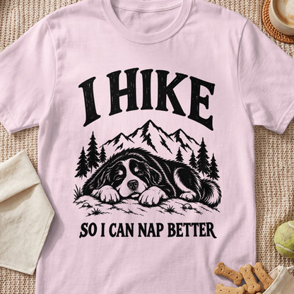Pink t-shirt with black text and illustration of a dog napping with mountains and trees.