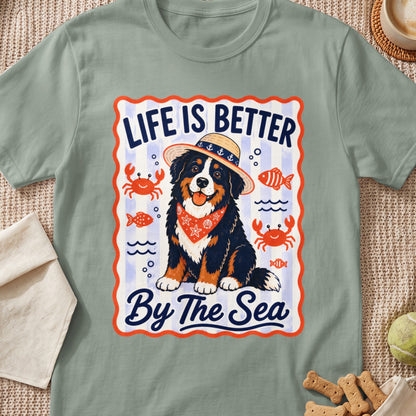 Bernese Mountain Dog wearing a straw hat and bandana, with "Life Is Better By The Sea" text.