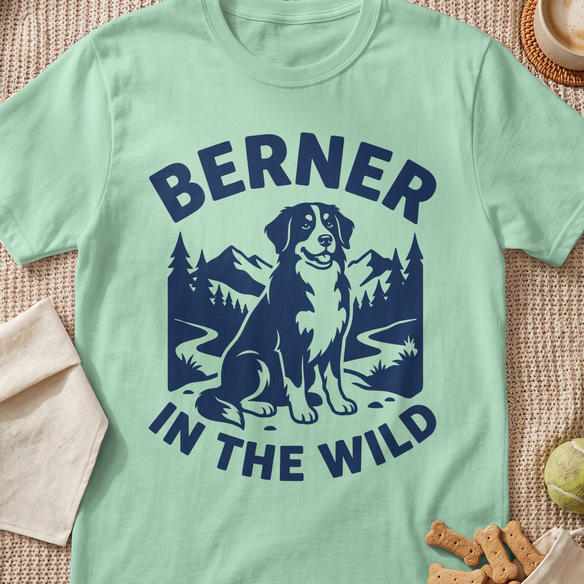 Light green t-shirt with navy blue graphic of a Bernese Mountain Dog and the words "BERNER IN THE WILD".