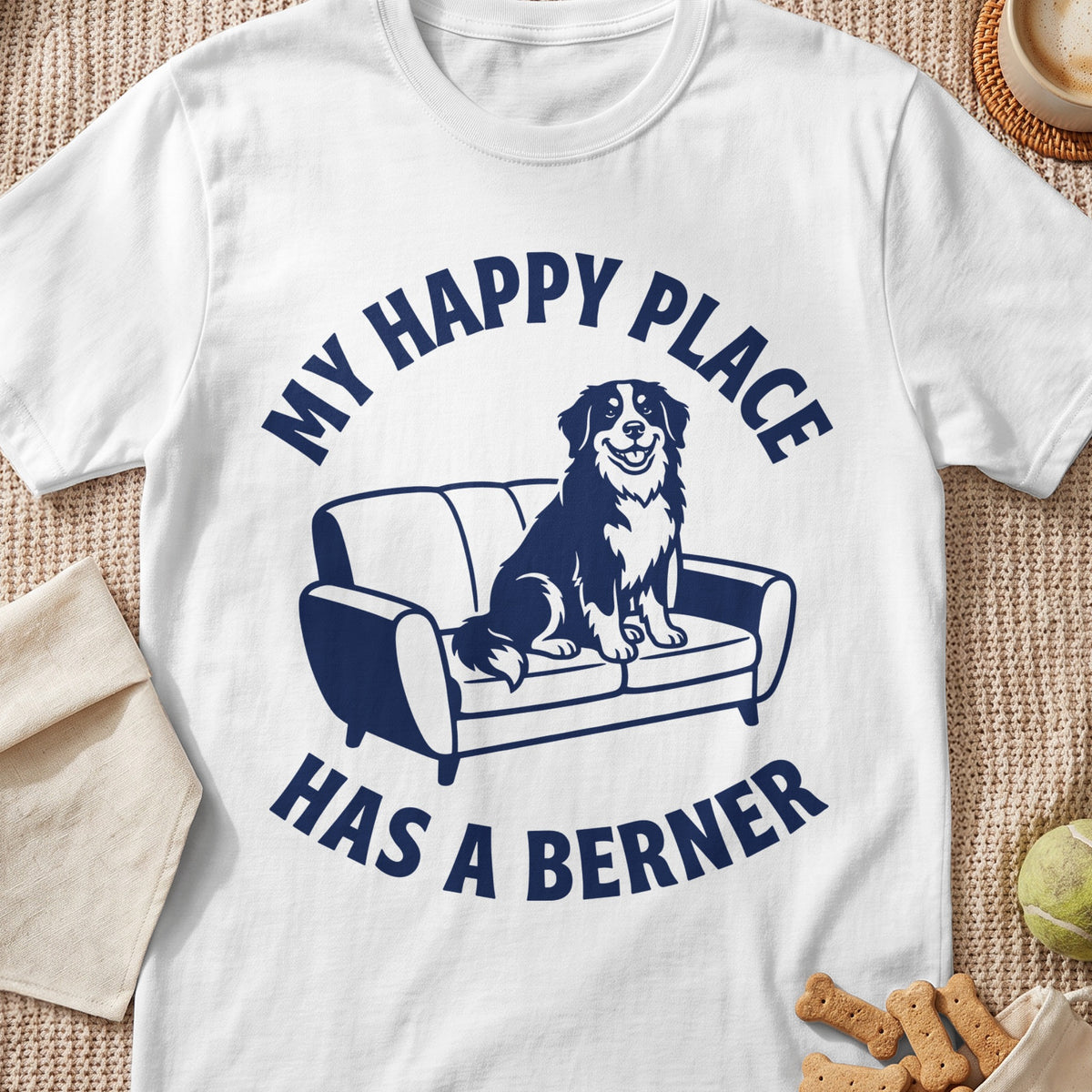 White t-shirt with navy blue graphic of a dog on a couch and text.