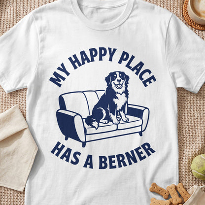 White t-shirt with navy blue graphic of a dog on a couch and text.
