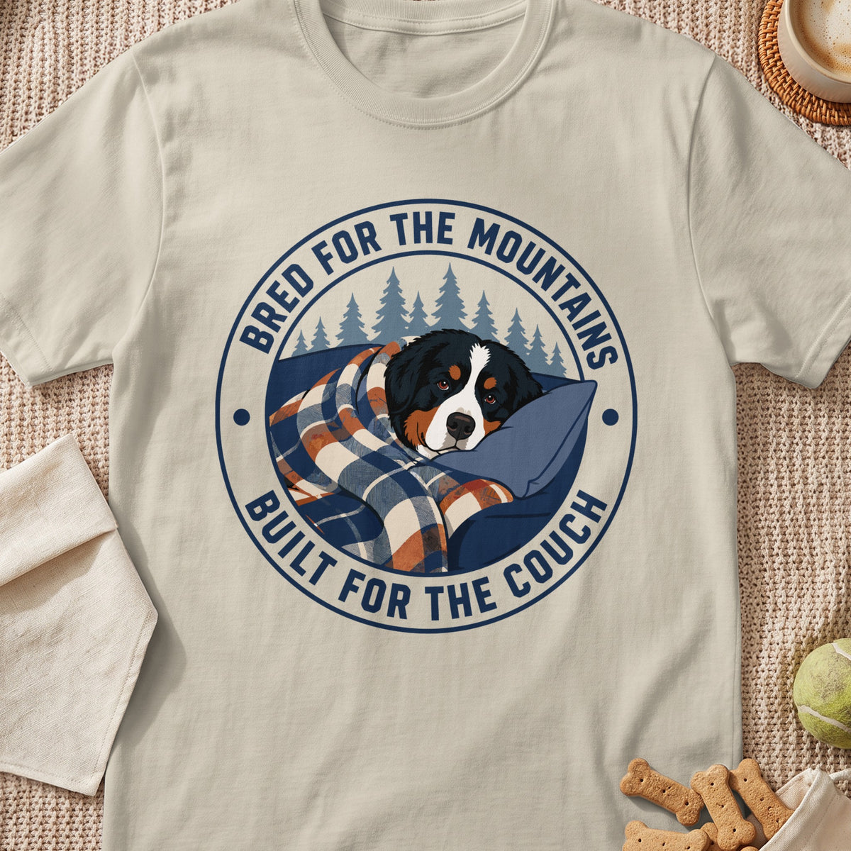 Bernese Mountain Dog wrapped in blanket with text "Bred for the Mountains, Built for the Couch".