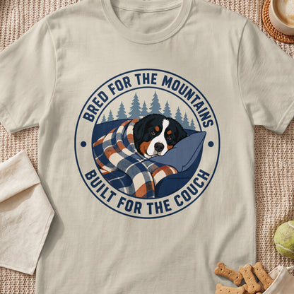 Bernese Mountain Dog wrapped in blanket with text "Bred for the Mountains, Built for the Couch".