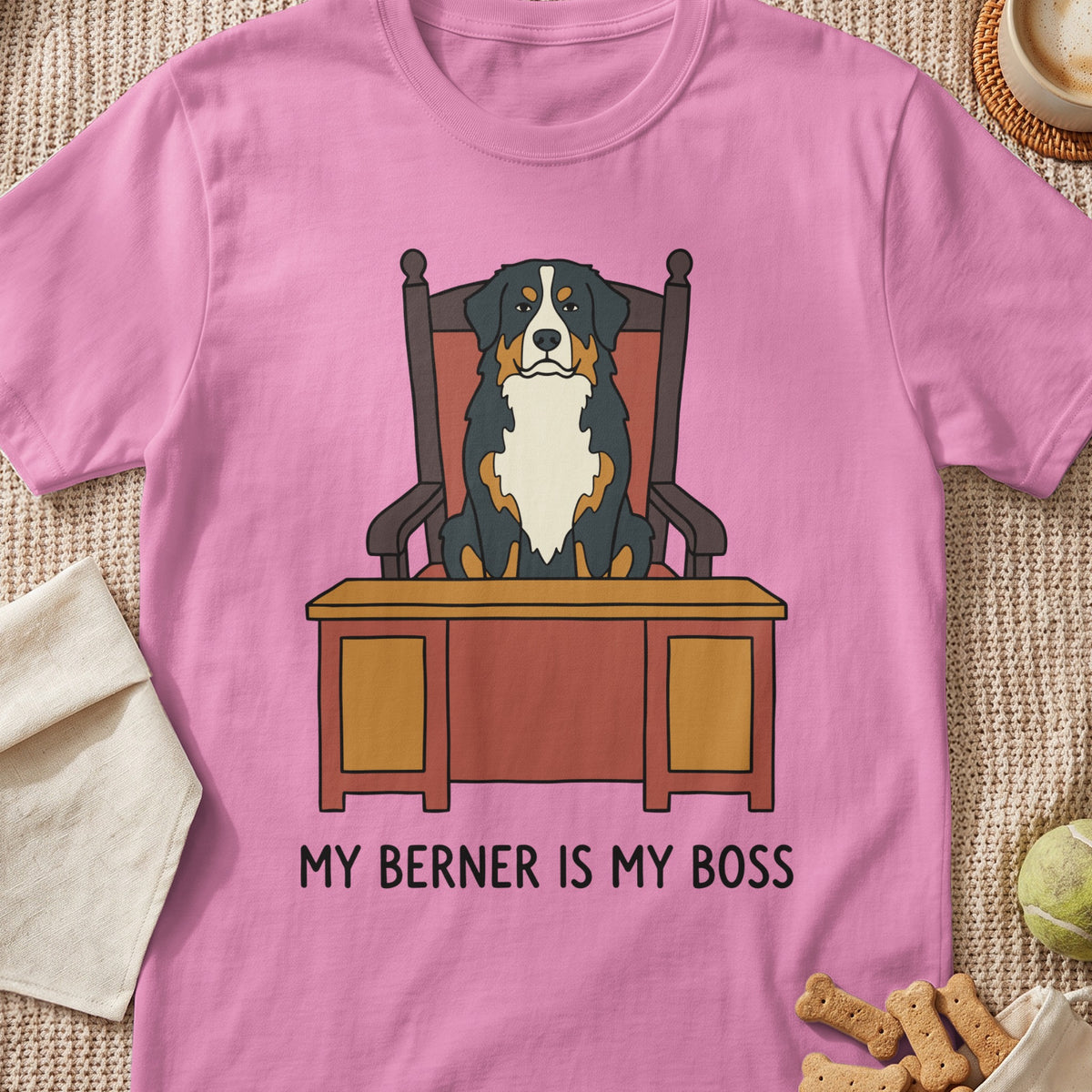 Pink t-shirt with cartoon Bernese Mountain Dog sitting at a desk saying "MY BERNER IS MY BOSS."