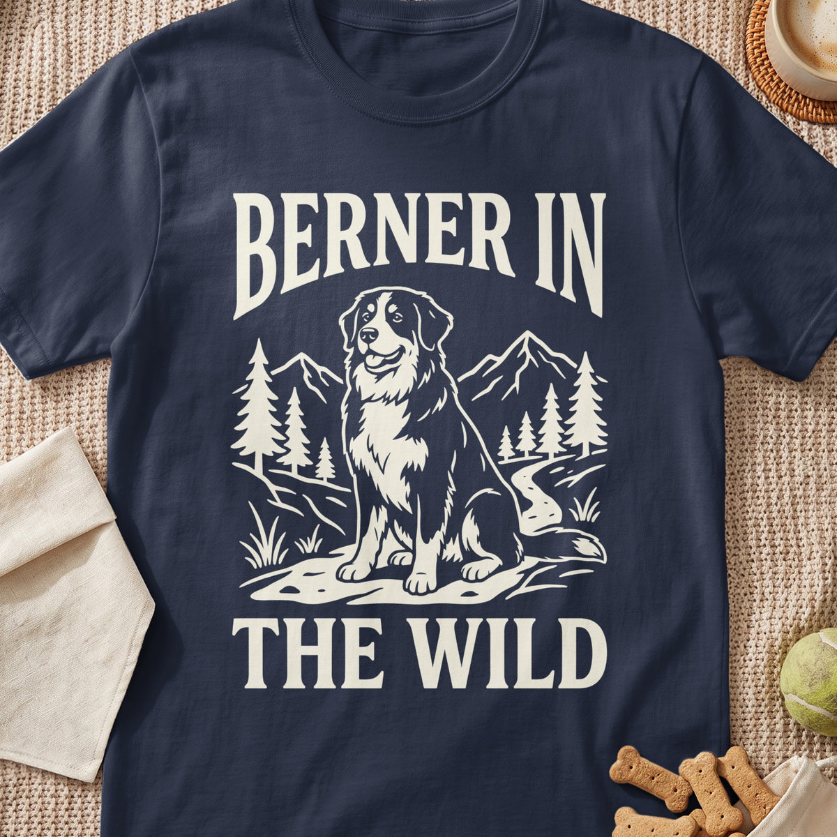 Navy t-shirt with cream text "BERNER IN THE WILD" and a dog in mountains.