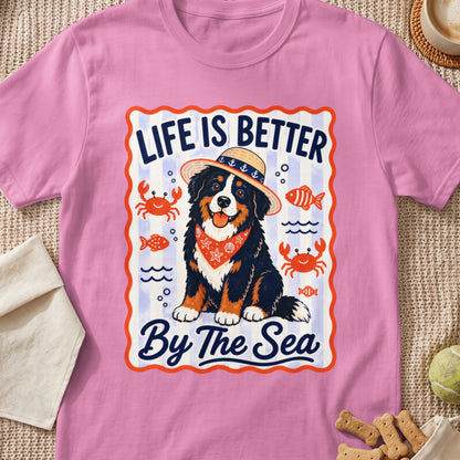 Bernese Mountain Dog wearing straw hat and bandana, with text "Life Is Better By The Sea."