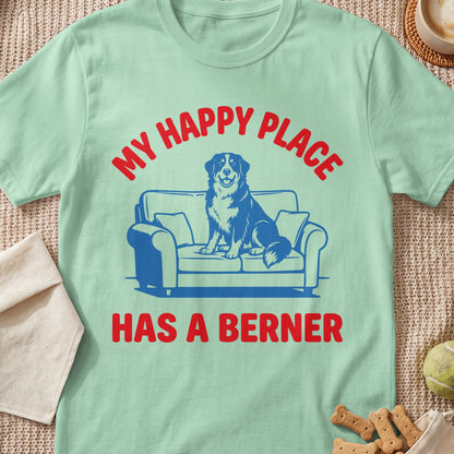 Light green t-shirt with red text "MY HAPPY PLACE HAS A BERNER" and a blue dog on a couch.