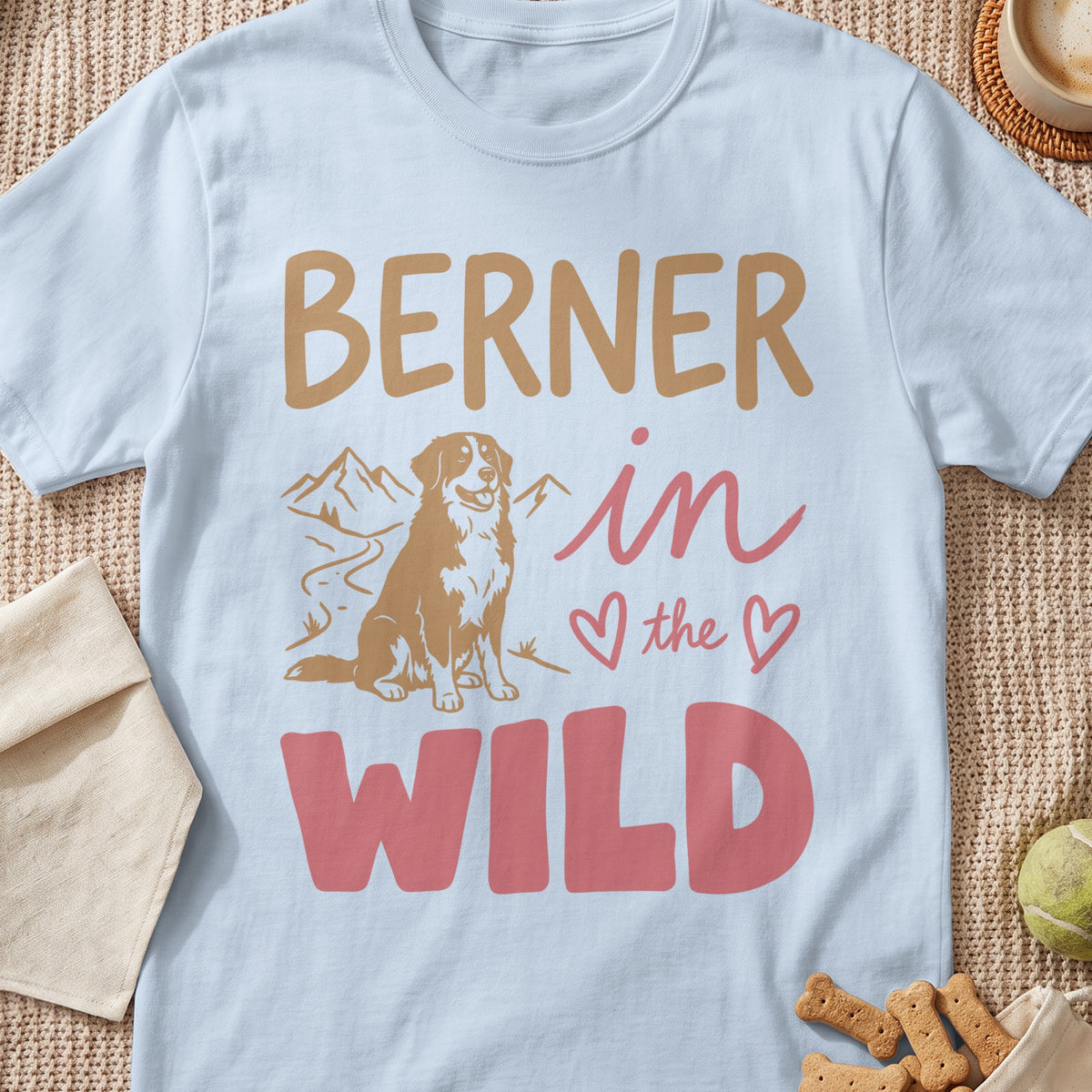Berner in the Wild graphic on a light blue t-shirt with dog and mountains.