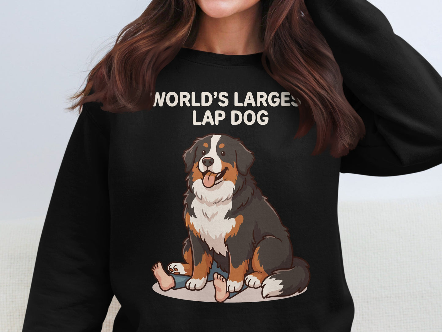 Black crewneck sweatshirt with "WORLD'S LARGEST LAP DOG" text and cartoon Bernese Mountain Dog.