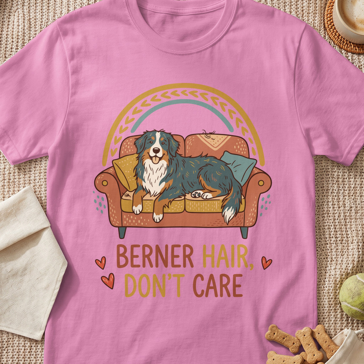 Pink t-shirt with a dog on a couch and text "BERNER HAIR, DON'T CARE".