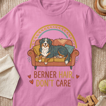 Pink t-shirt with a dog on a couch and text "BERNER HAIR, DON'T CARE".