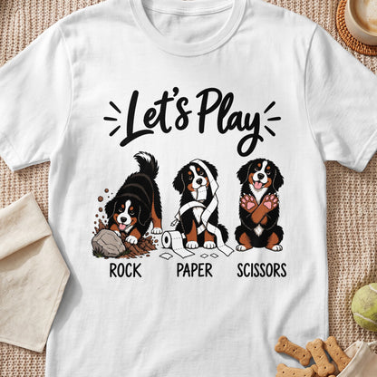Bernese Mountain Dogs playing Rock Paper Scissors on a white t-shirt.
