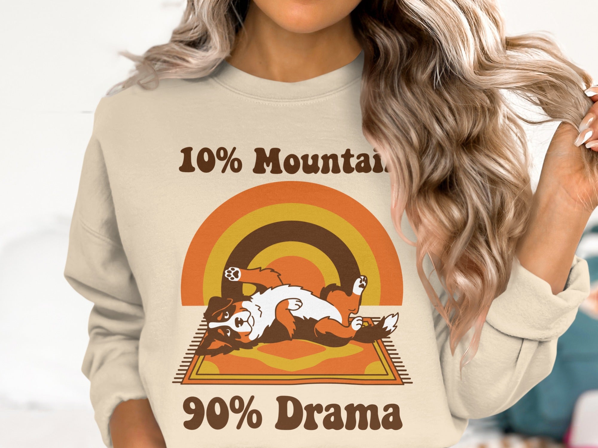 Cream sweatshirt with a retro rainbow, a Bernese Mountain Dog laying on a rug, and text.
