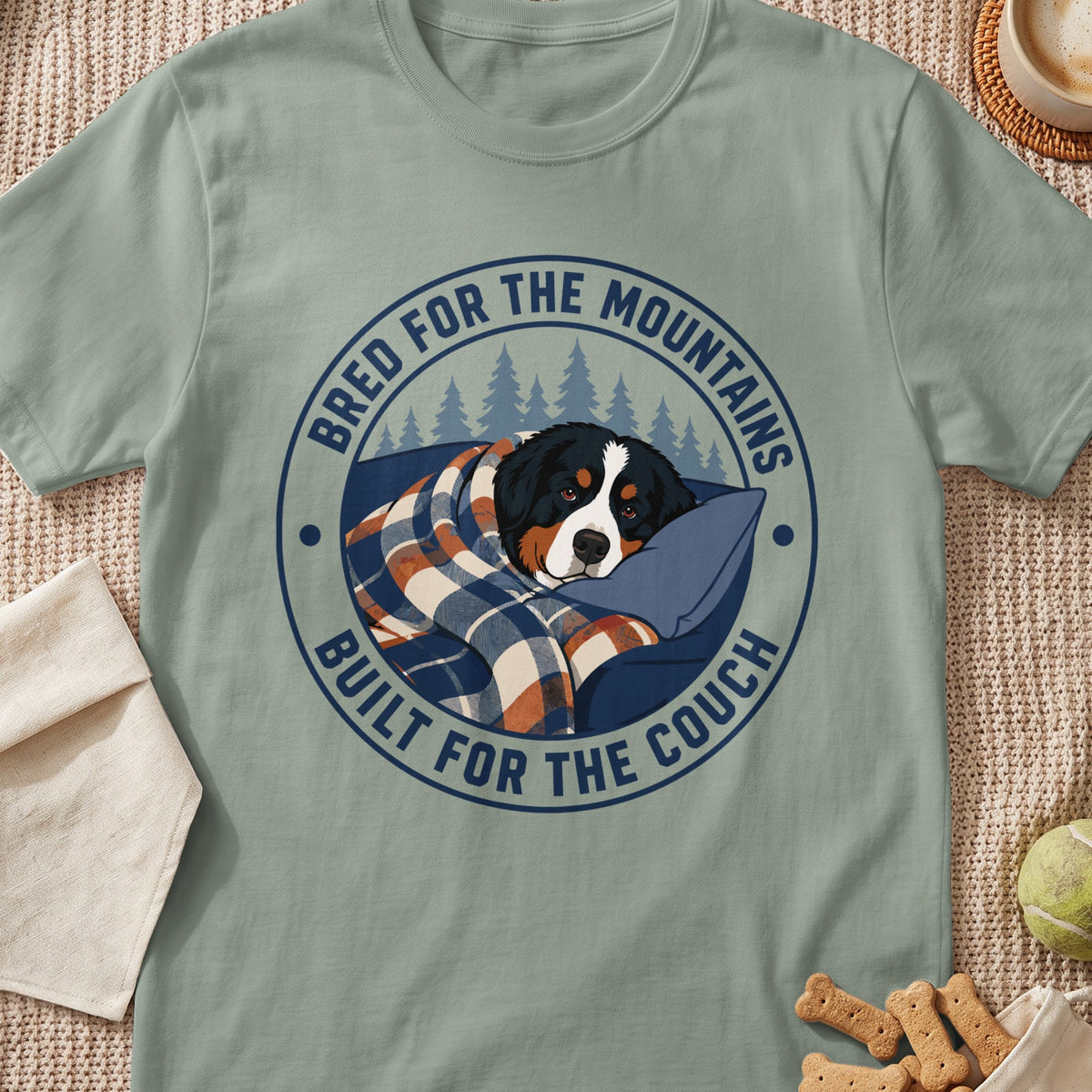 Bernese Mountain Dog wrapped in blanket with text "Bred for the Mountains, Built for the Couch".