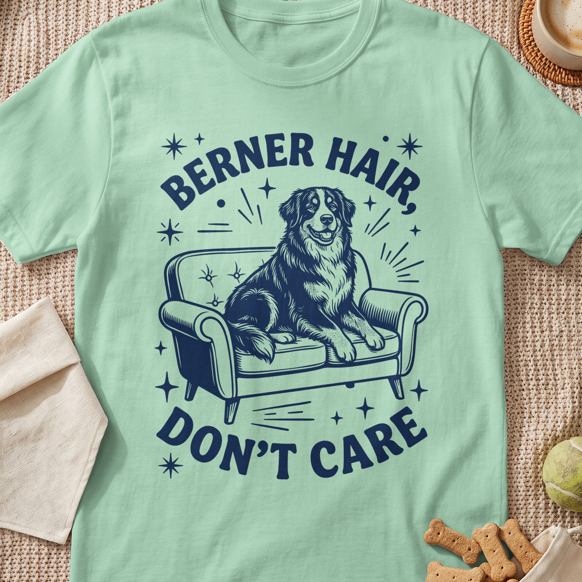 Berner hair don't care text with a dog sitting on a couch.