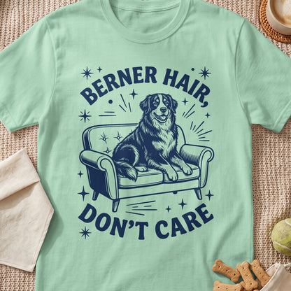 Berner hair don't care text with a dog sitting on a couch.