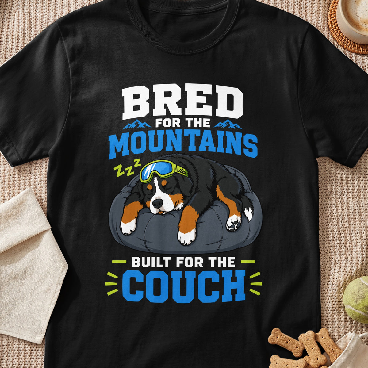 Black t-shirt with "Bred for the Mountains, Built for the Couch" text and sleeping dog graphic.