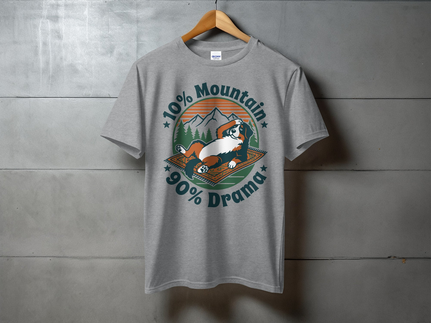 Grey t-shirt with a dog on a rug, mountains, trees, and text "10% Mountain 90% Drama".