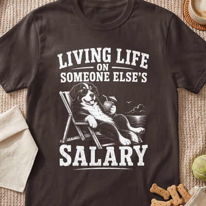 Dog wearing sunglasses on a lounge chair with "Living life on someone else's salary" text.