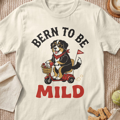 Bernese Mountain Dog wearing sunglasses rides a scooter with text "Bern to Be Mild".
