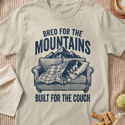 T-shirt graphic with text "Bred for the mountains" and a dog sleeping on a couch.