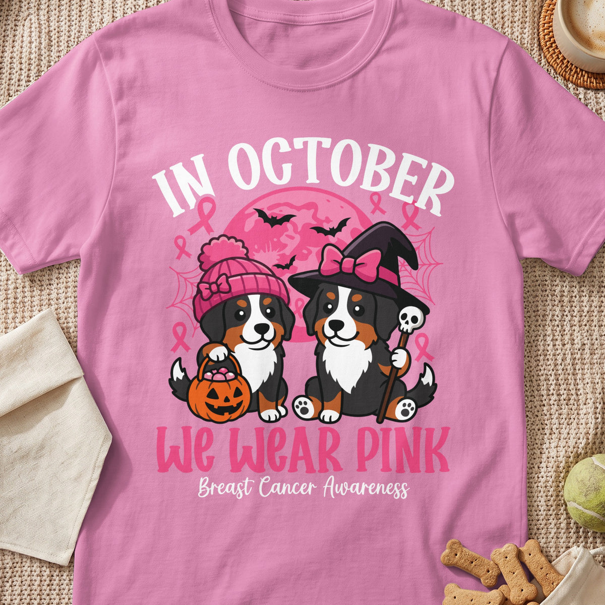 Two Bernese Mountain Dogs in Halloween costumes with "In October We Wear Pink" text.