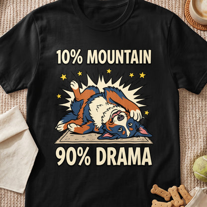 A black t-shirt printed with a Bernese Mountain Dog lying on its back and the text 10% mountain 90% drama.