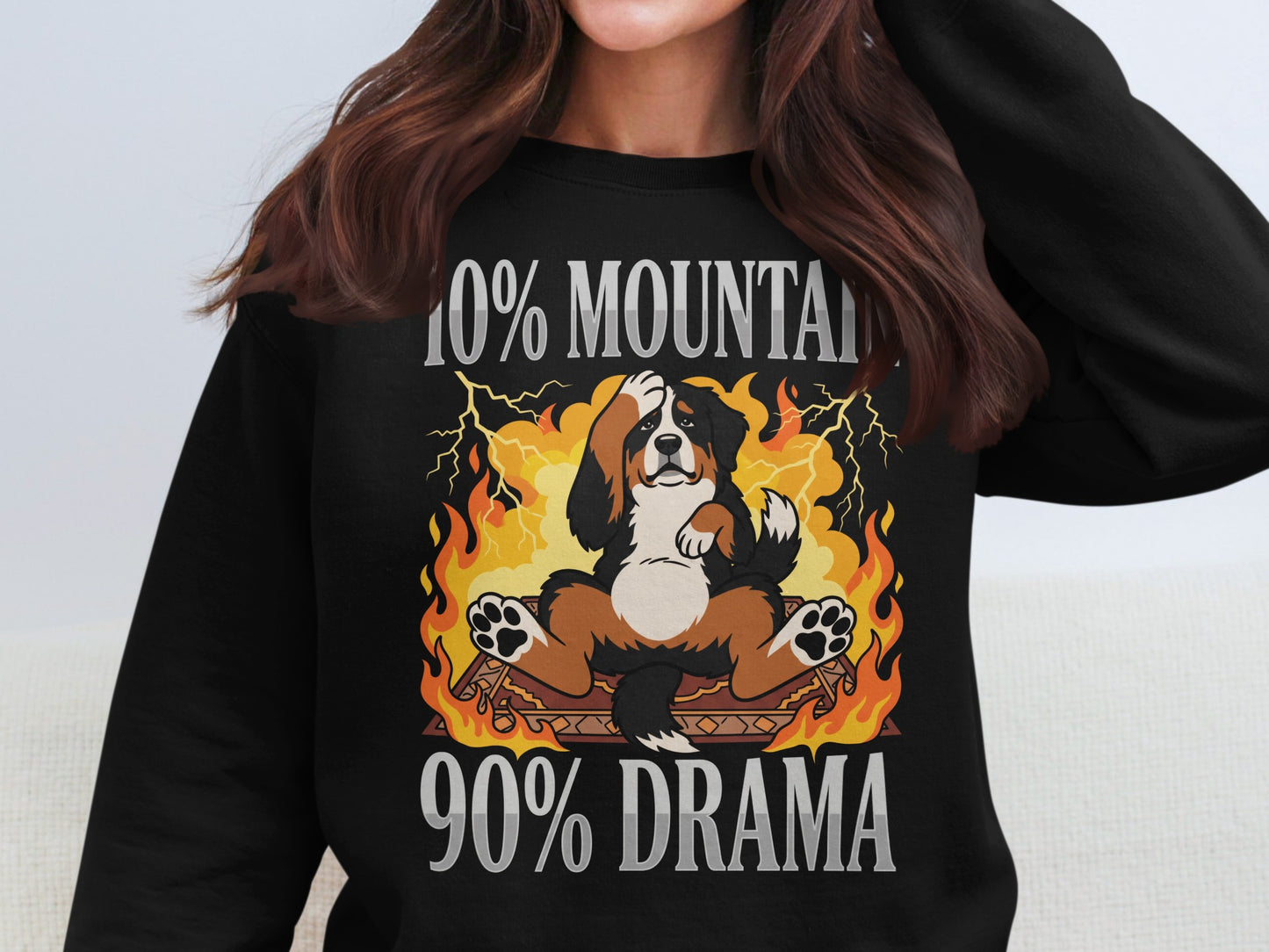 Bernese mountain dog sitting in flames with text "90% Mountain 90% Drama".