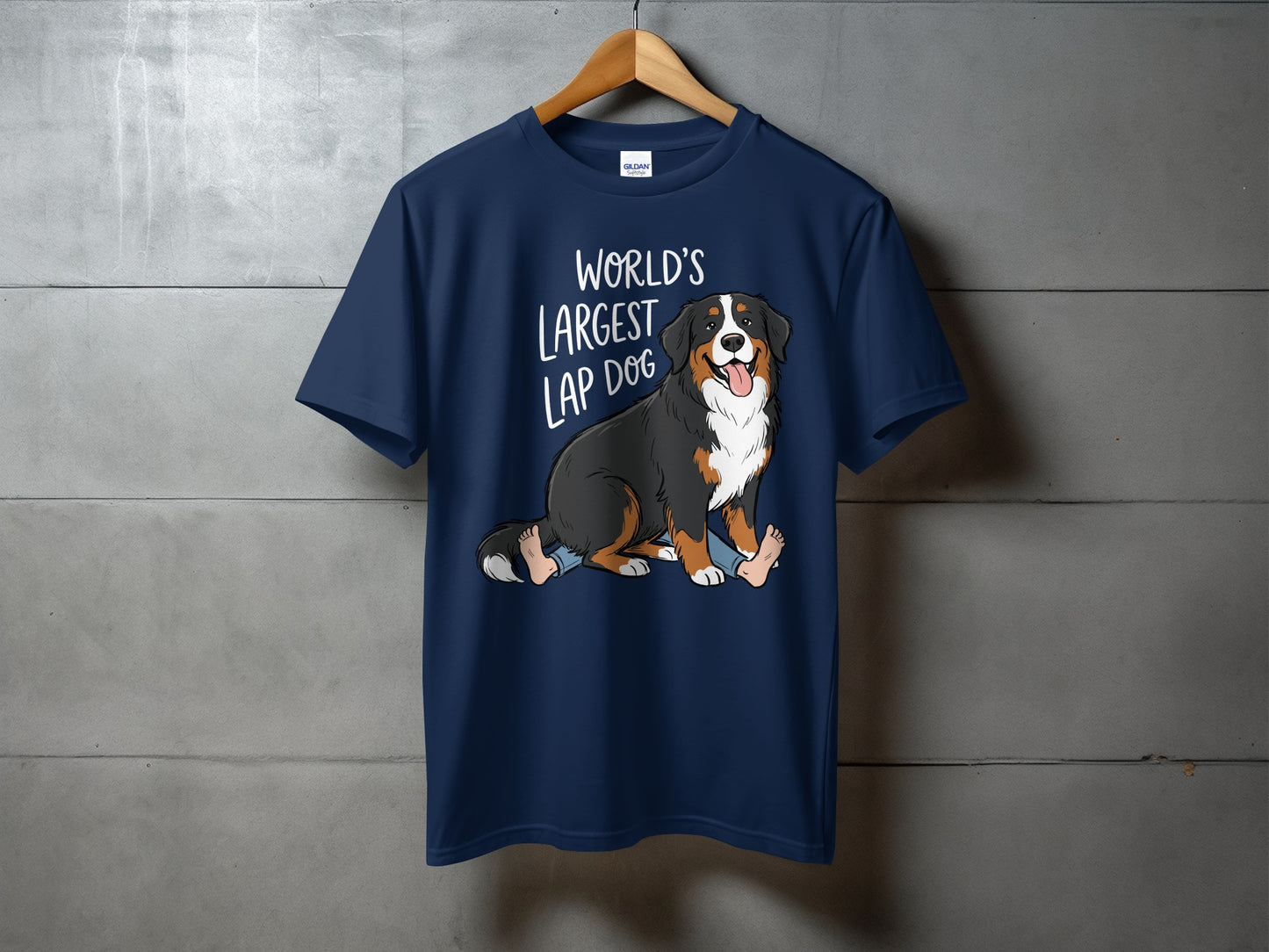 Navy t-shirt with animated Bernese Mountain Dog sitting on a person, text "World's Largest Lap Dog".