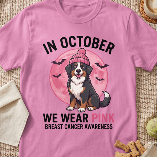Bernese Mountain Dog in pink beanie with "In October We Wear Pink" text for breast cancer awareness.