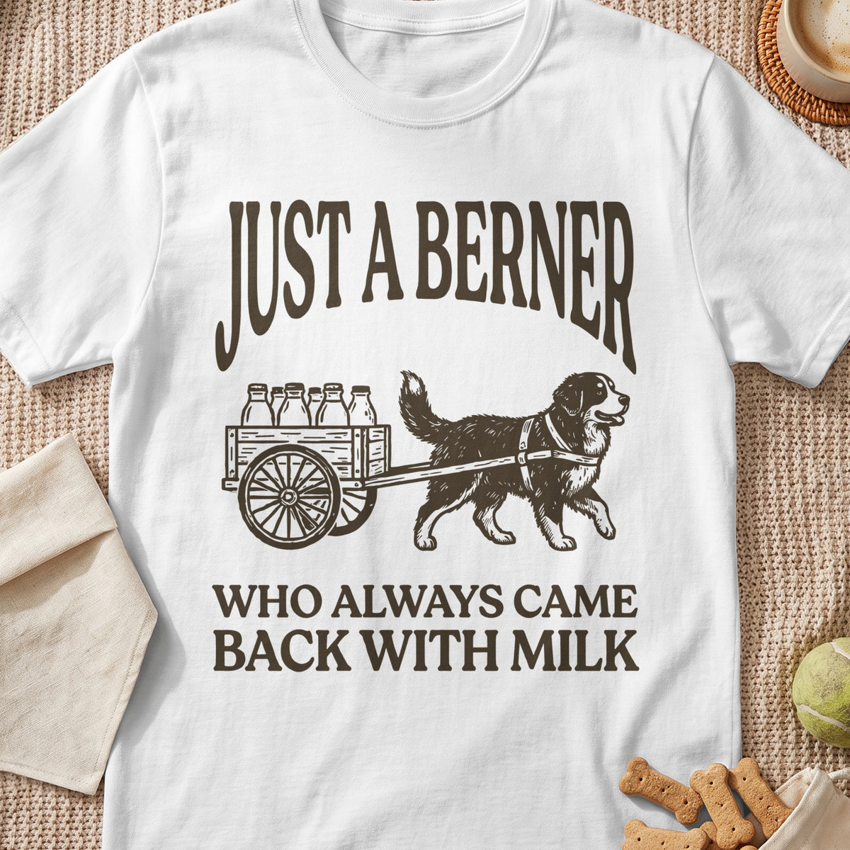 White t-shirt with brown text: "JUST A BERNER WHO ALWAYS CAME BACK WITH MILK".
