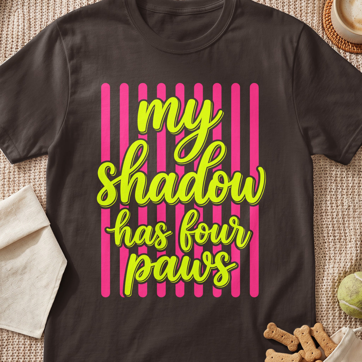 Dark brown t-shirt with neon green text "my shadow has four paws"