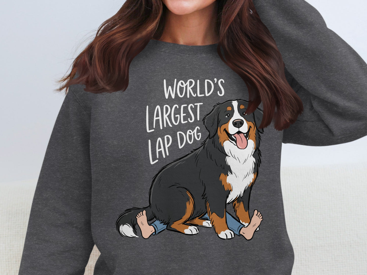 Bernese Mountain Dog with text "World's Largest Lap Dog" on a grey sweatshirt.
