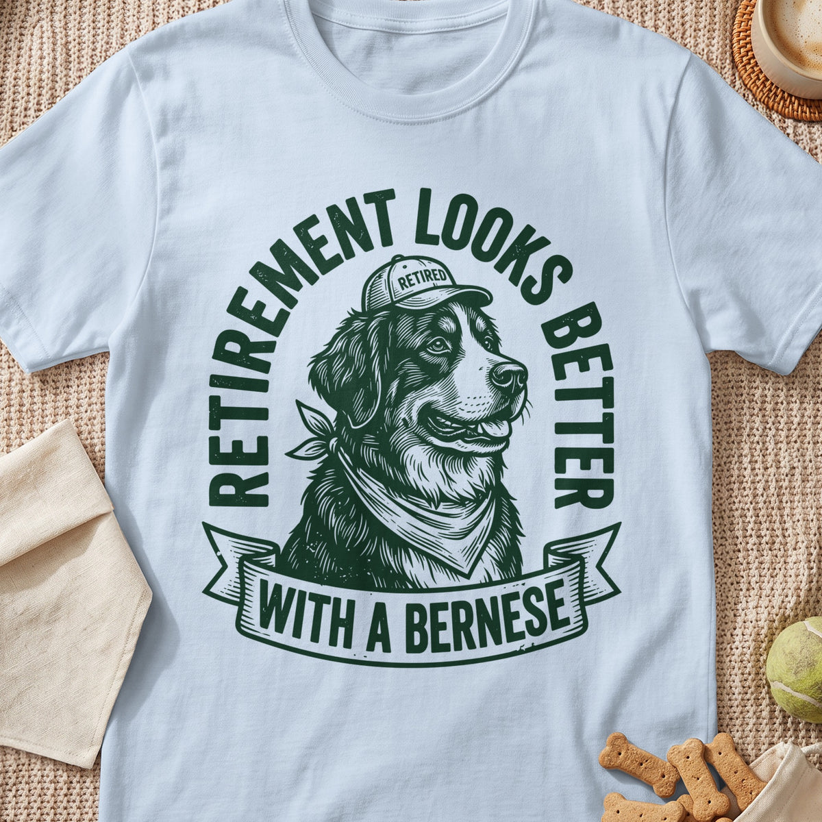 Bernese dog wearing a "Retired" cap and bandana, "Retirement Looks Better With A Bernese" text.