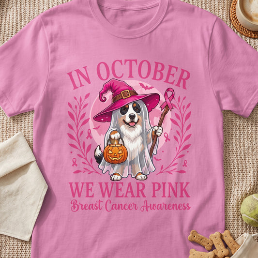 Pink t-shirt with dog in ghost costume and pumpkin, text "In October We Wear Pink Breast Cancer Awareness."