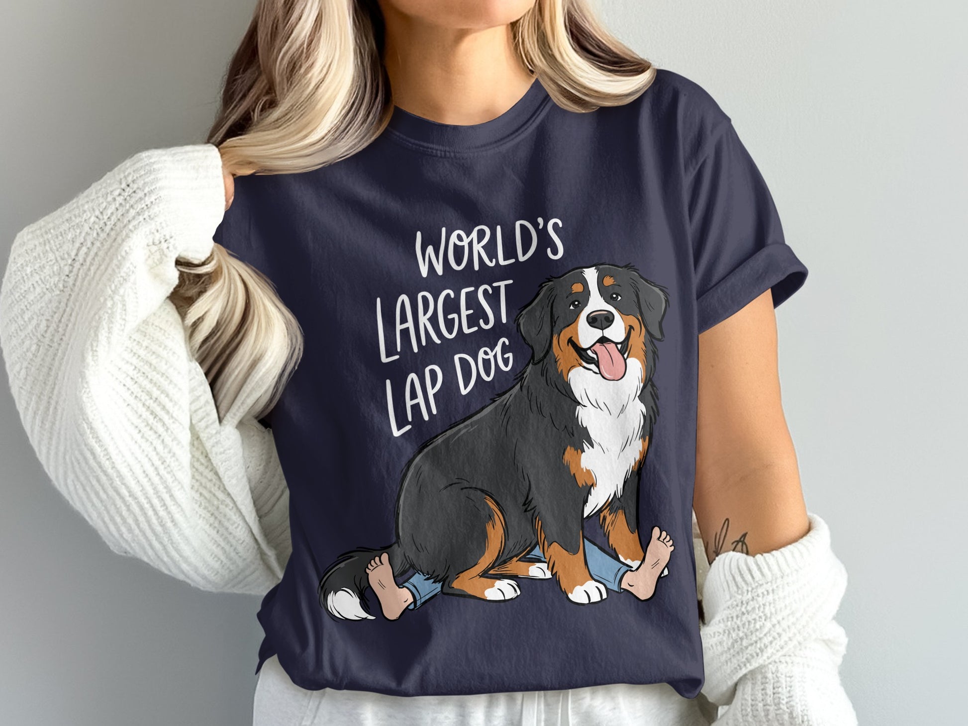 Navy t-shirt with cartoon Bernese Mountain Dog sitting on human legs with text "WORLD'S LARGEST LAP DOG".