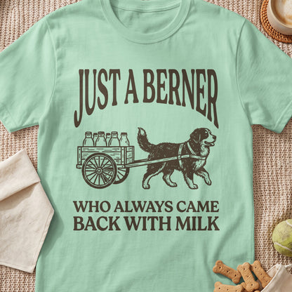 Light green t-shirt with brown text and illustration of a Bernese Mountain Dog pulling a milk cart.