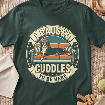 Bernese Mountain Dog wearing sunglasses and cap on couch, "I paused cuddles to be here" text.