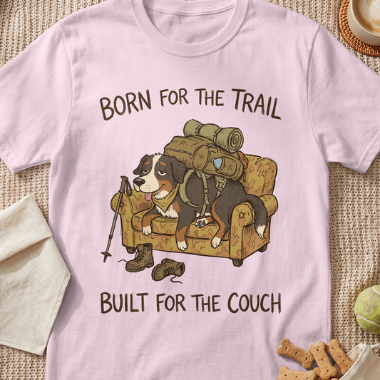 Bernese Mountain Dog on couch with backpack, "Born for the Trail, Built for the Couch" text.