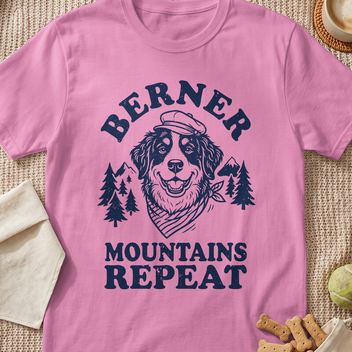 Pink t-shirt with graphic of Bernese dog, mountains, and text "BERNER MOUNTAINS REPEAT."