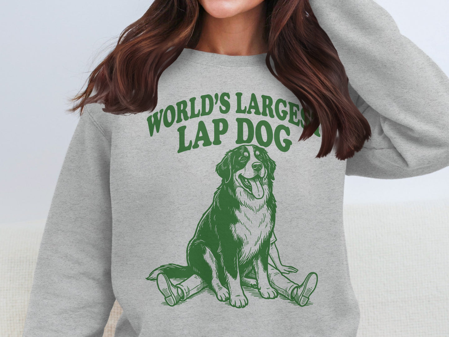 Grey sweatshirt with a green graphic of a dog and "World's Largest Lap Dog" text.